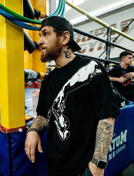 Мужчина в футболке BOXRAW в боксерском зале